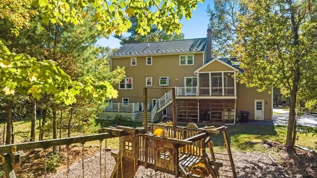 a aerial view of a house with large trees