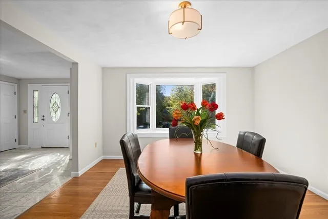 a dining room with furniture and wooden floor
