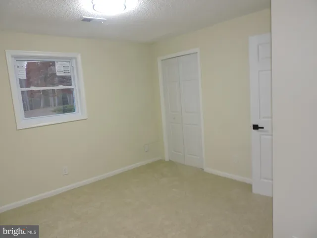 a view of a field with trees in the background