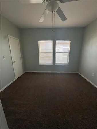 a view of a livingroom with a ceiling fan and window