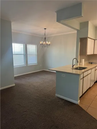 a kitchen with cabinets and stainless steel appliances