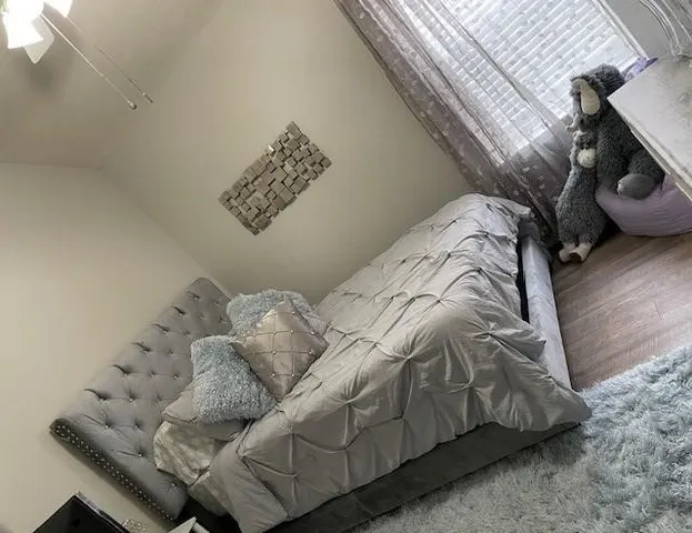 a bed with white sheets and pillows on it