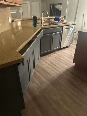 a kitchen with stainless steel appliances granite countertop a sink a stove and a refrigerator