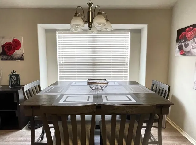 a view of a dining room with furniture and window