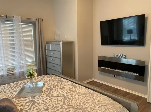 a bedroom with a bed and a flat screen tv