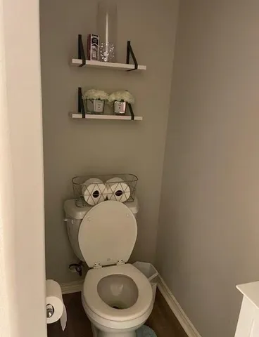 a white toilet sitting next to a sink