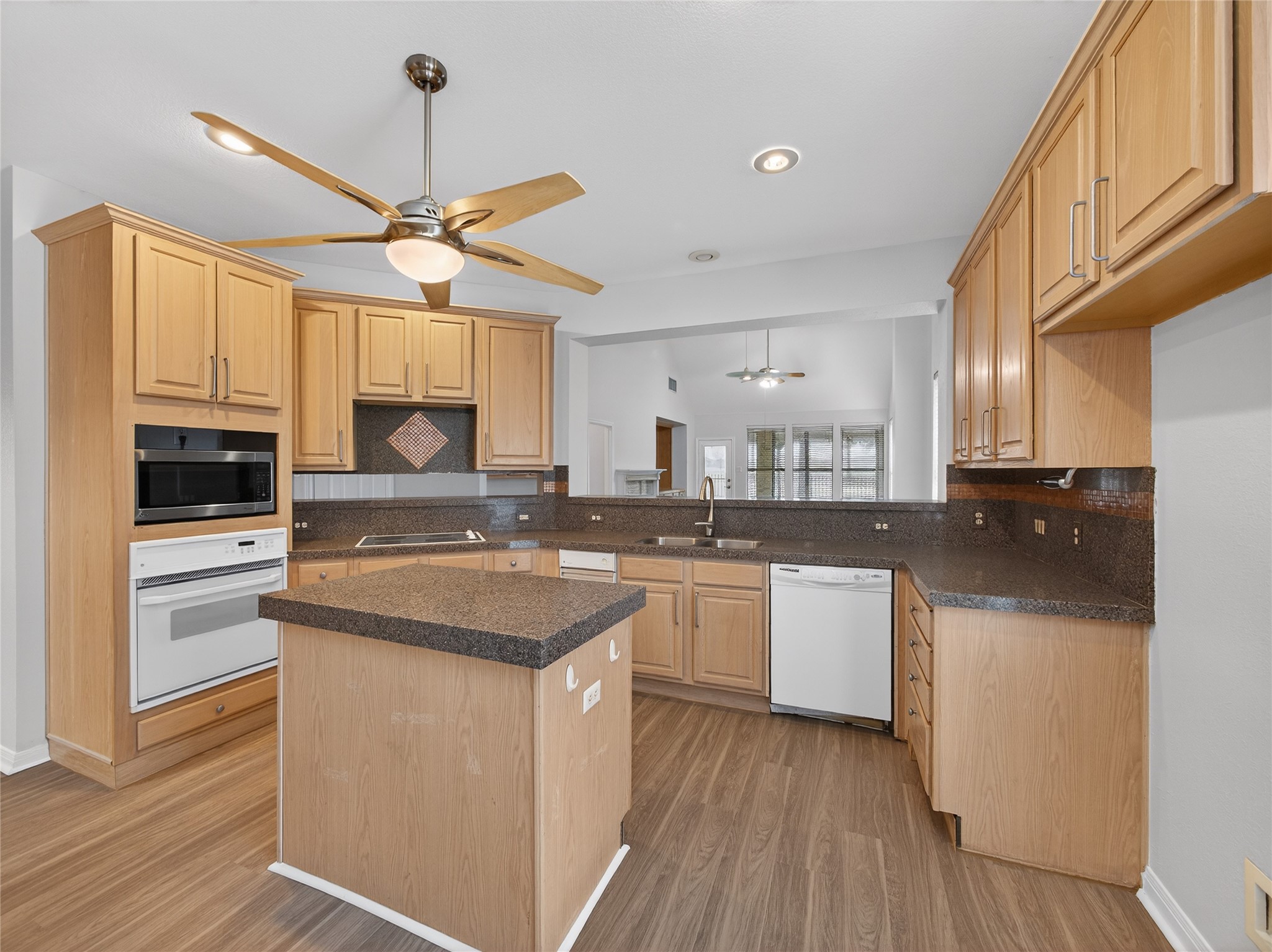 11029 Ballybunion Place Austin, TX 78747 - Photo 12 of 40 a kitchen with stainless steel appliances granite countertop a sink stove and refrigerator