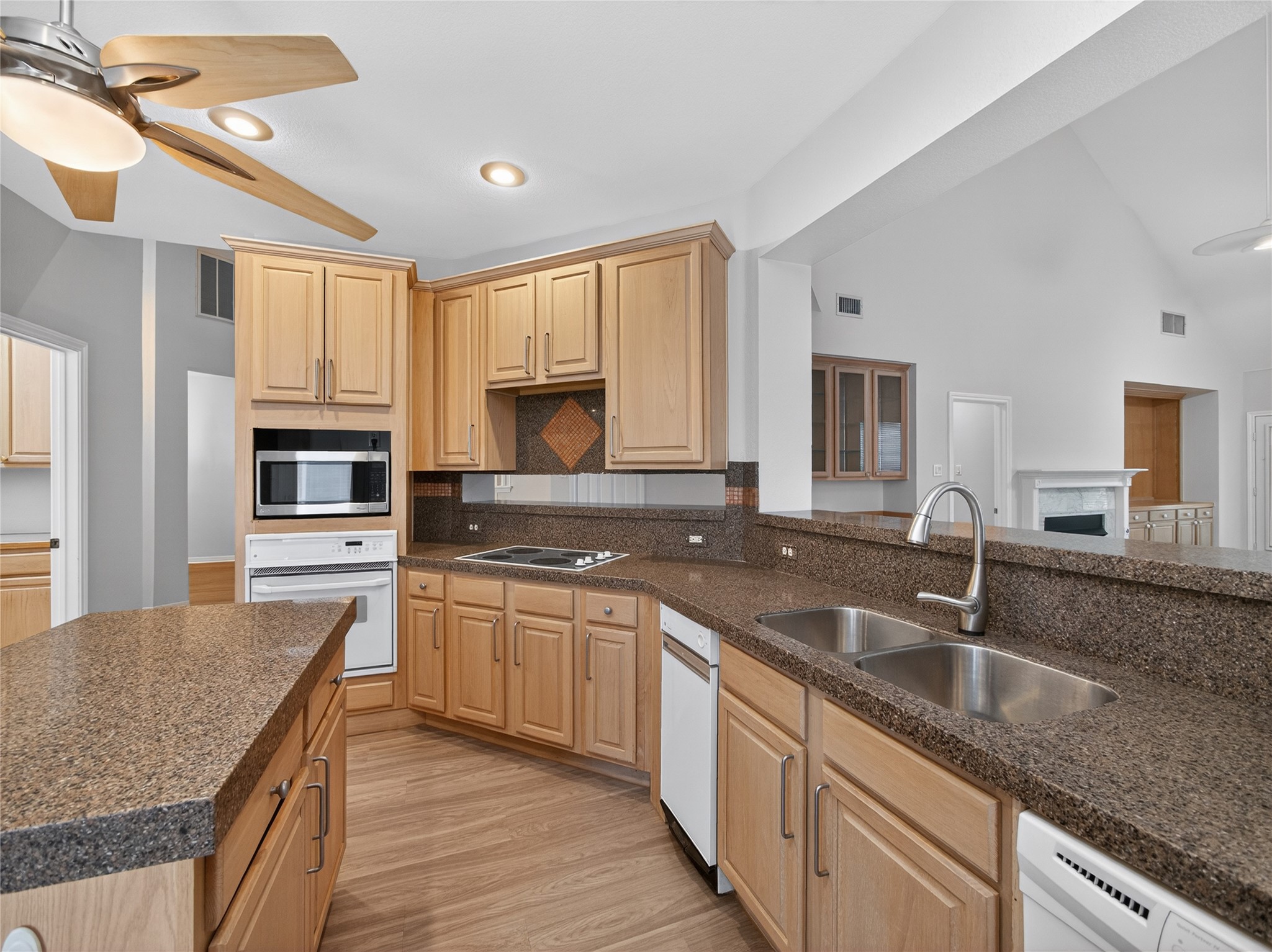 11029 Ballybunion Place Austin, TX 78747 - Photo 13 of 40 a kitchen with stainless steel appliances granite countertop a sink stove and cabinets