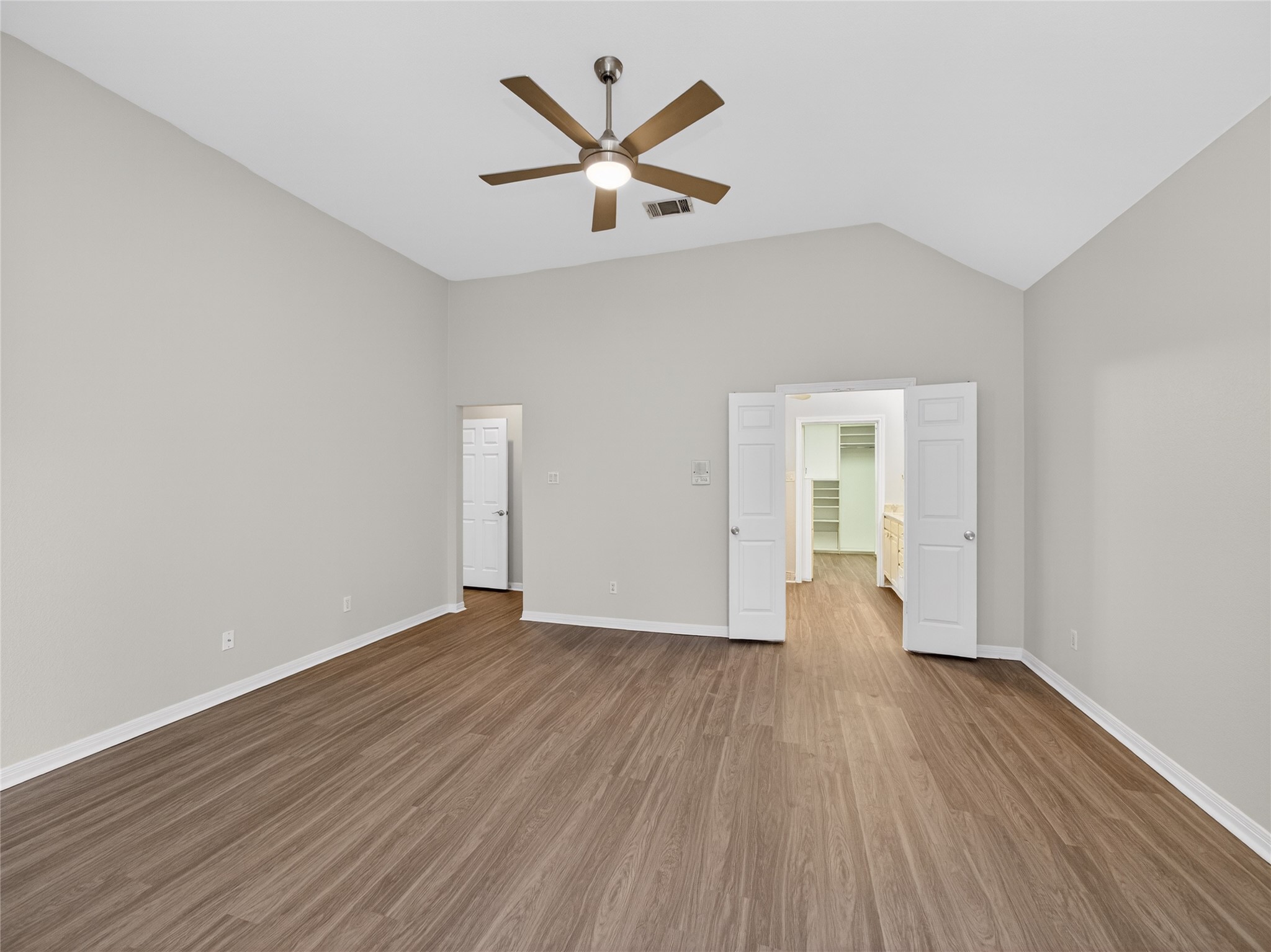 11029 Ballybunion Place Austin, TX 78747 - Photo 18 of 40 an empty room with wooden floor and a ceiling fan