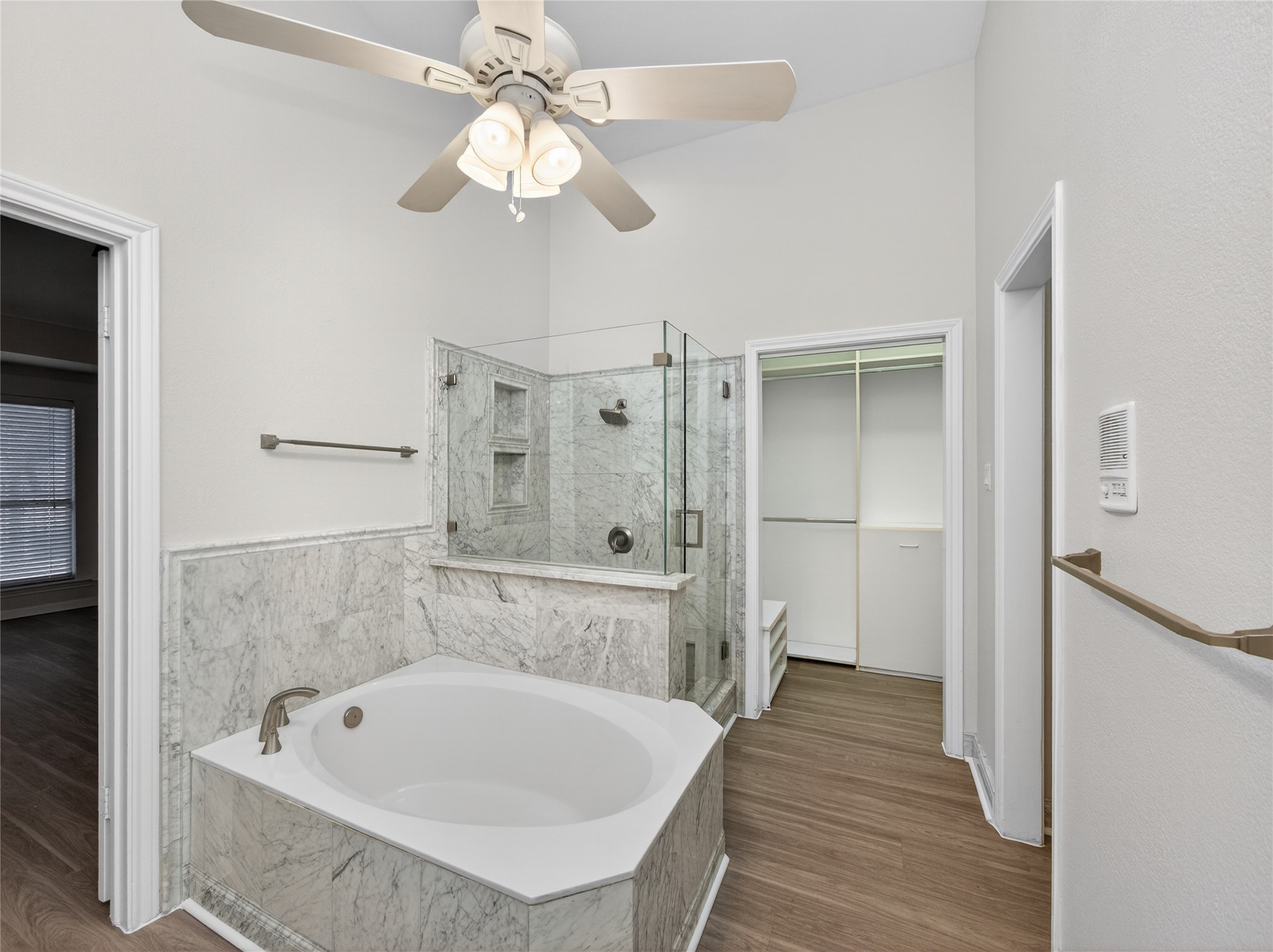 11029 Ballybunion Place Austin, TX 78747 - Photo 20 of 40 a bathroom with a tub a sink and a chandelier
