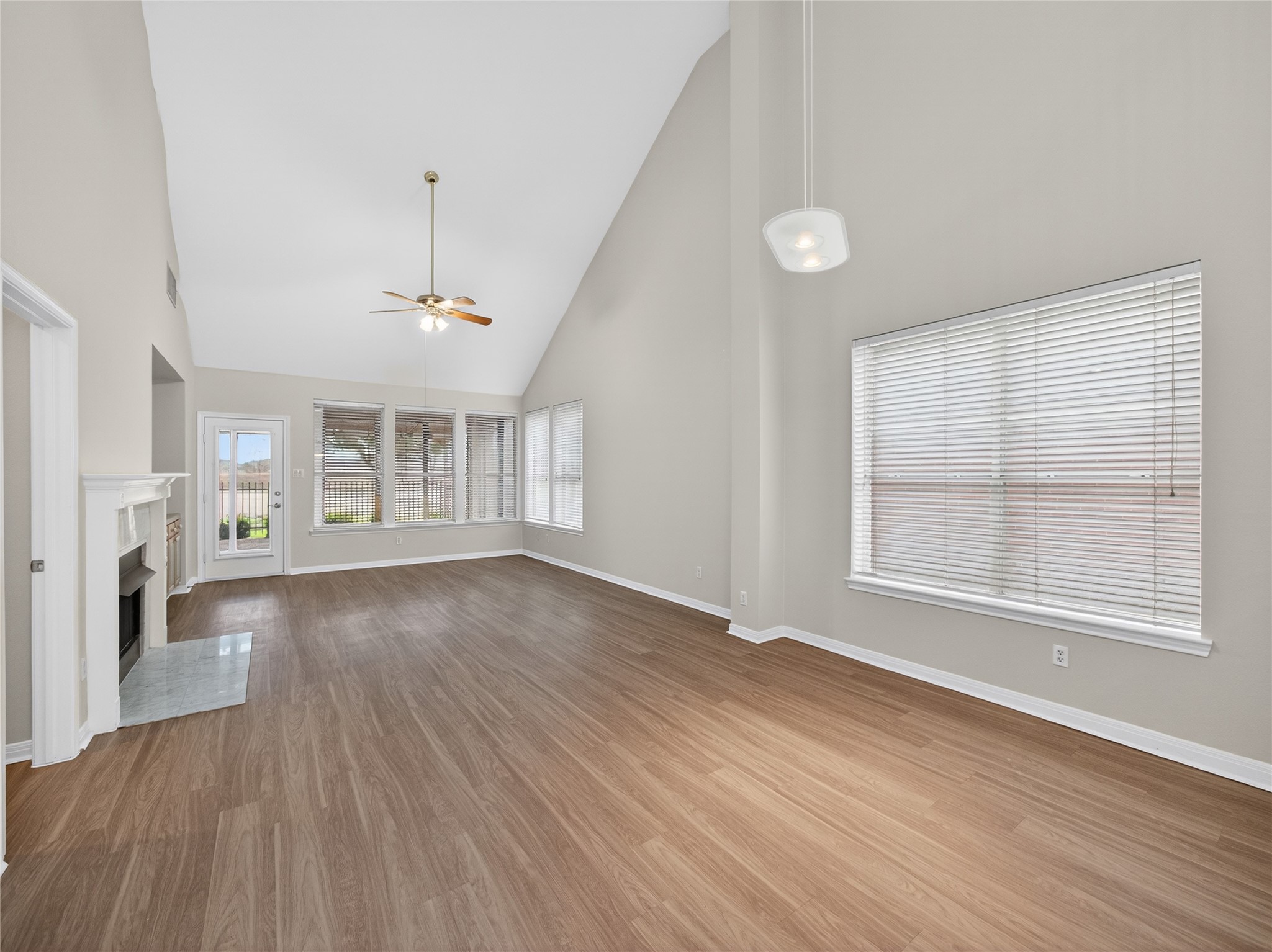 11029 Ballybunion Place Austin, TX 78747 - Photo 8 of 40 an empty room with wooden floor and windows
