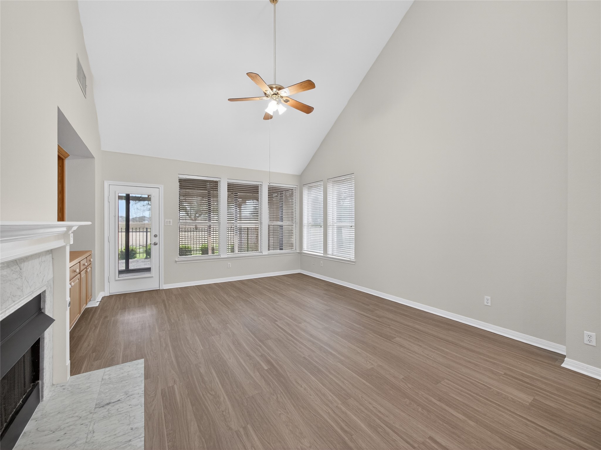 11029 Ballybunion Place Austin, TX 78747 - Photo 9 of 40 a view of an empty room with wooden floor and a window