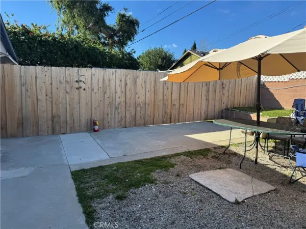 a backyard view with a seating space