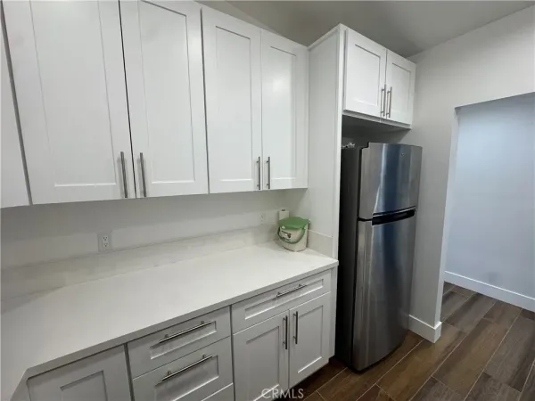 a kitchen with appliances and a refrigerator
