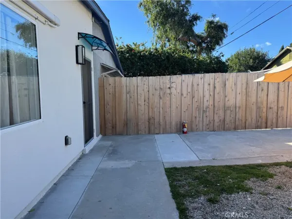 a view of backyard with wooden fence