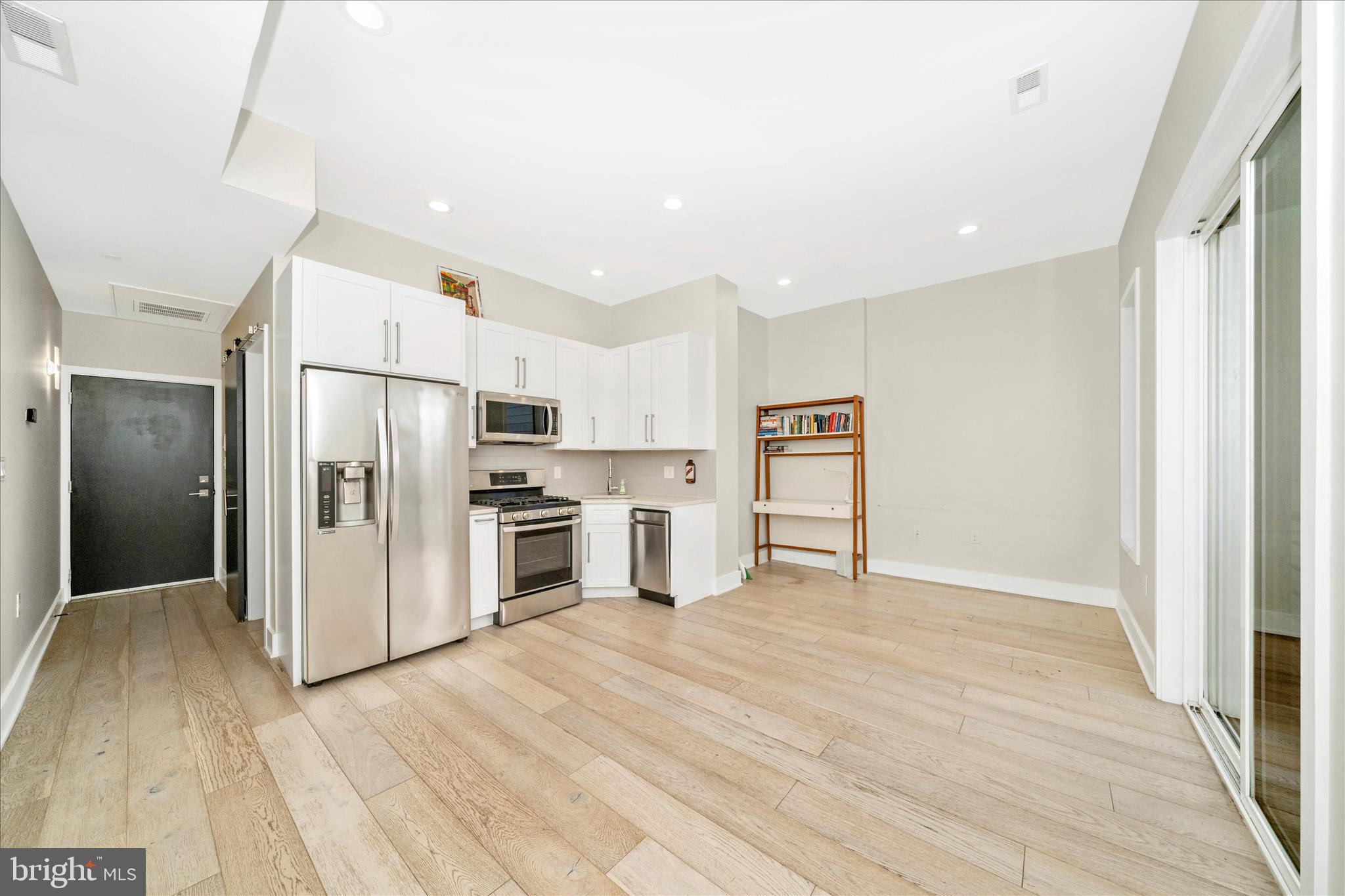 7129 Georgia Avenue Northwest, Unit 4 Washington, DC 20012 - Photo 11 of 30 a kitchen with stainless steel appliances a refrigerator and a stove top oven