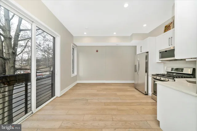 a view of a room with wooden floor and balcony