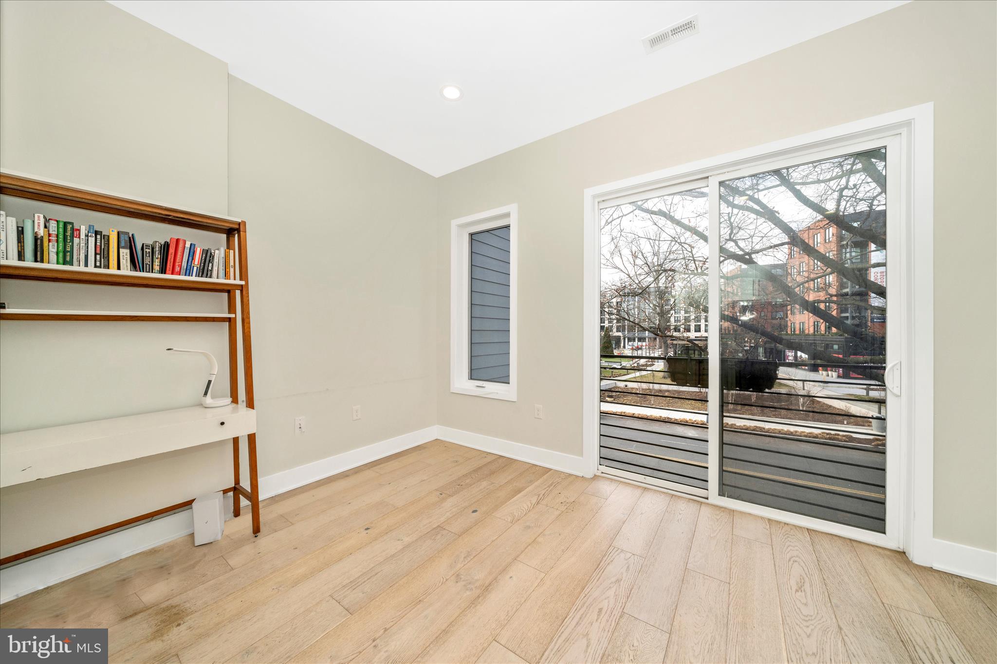 7129 Georgia Avenue Northwest, Unit 4 Washington, DC 20012 - Photo 16 of 30 a view of a room with wooden floor and balcony
