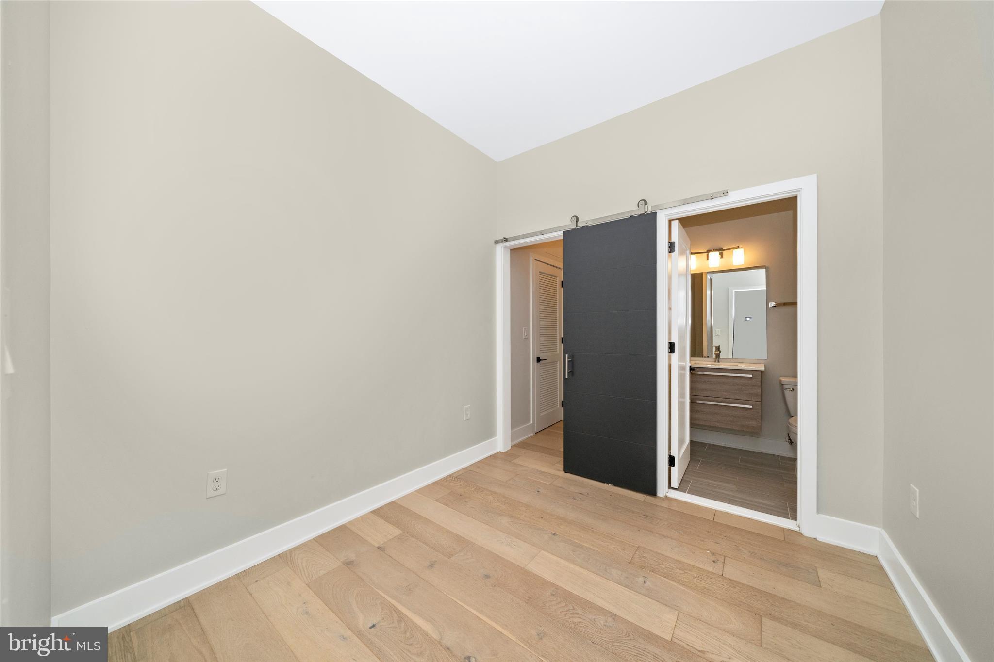 7129 Georgia Avenue Northwest, Unit 4 Washington, DC 20012 - Photo 17 of 30 a view of an empty room with closet and wooden floor