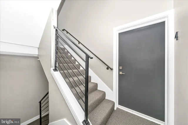 a kitchen with cabinets stainless steel appliances and wooden floor