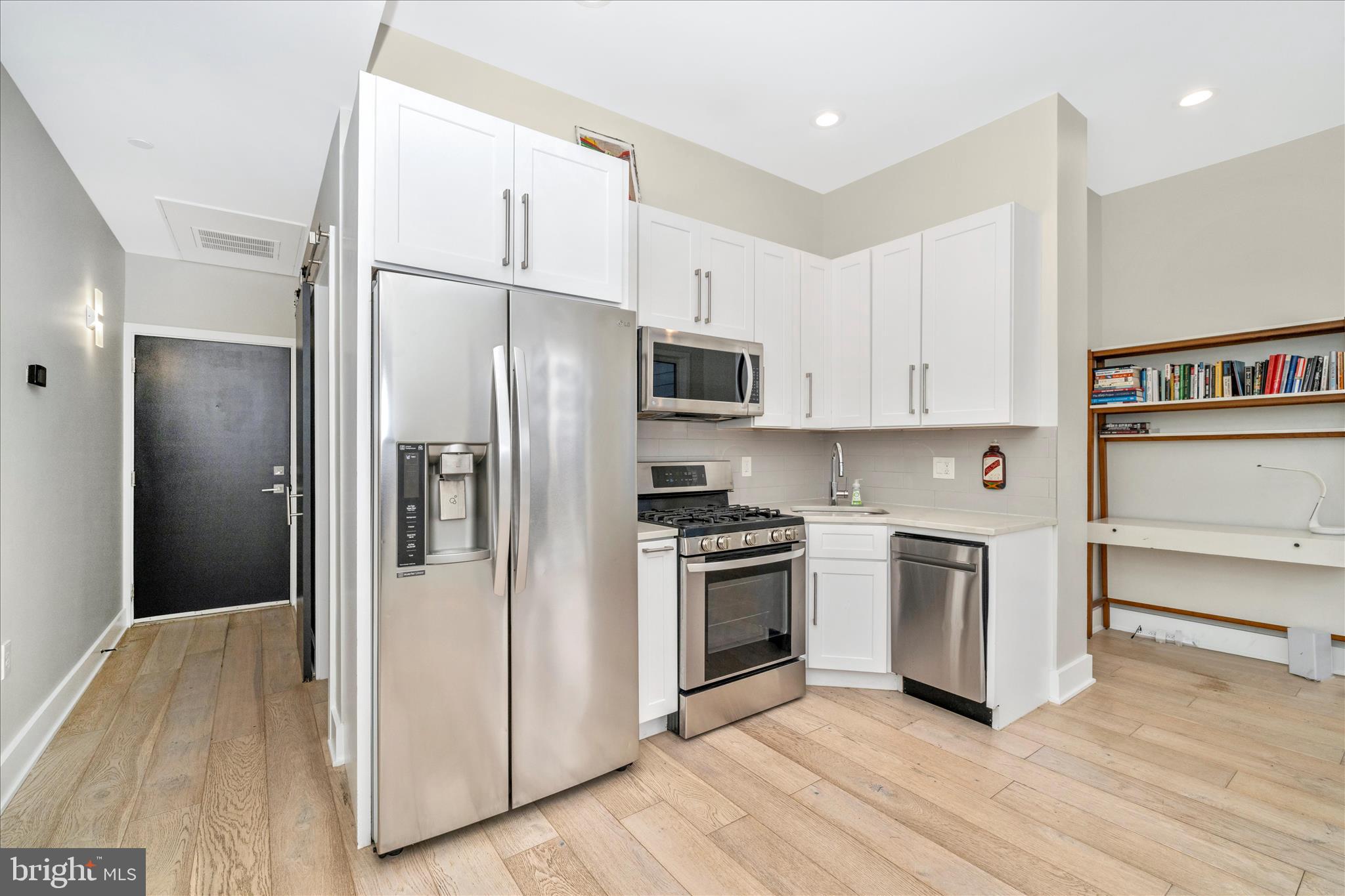 7129 Georgia Avenue Northwest, Unit 4 Washington, DC 20012 - Photo 9 of 30 a kitchen with stainless steel appliances a refrigerator sink and stove