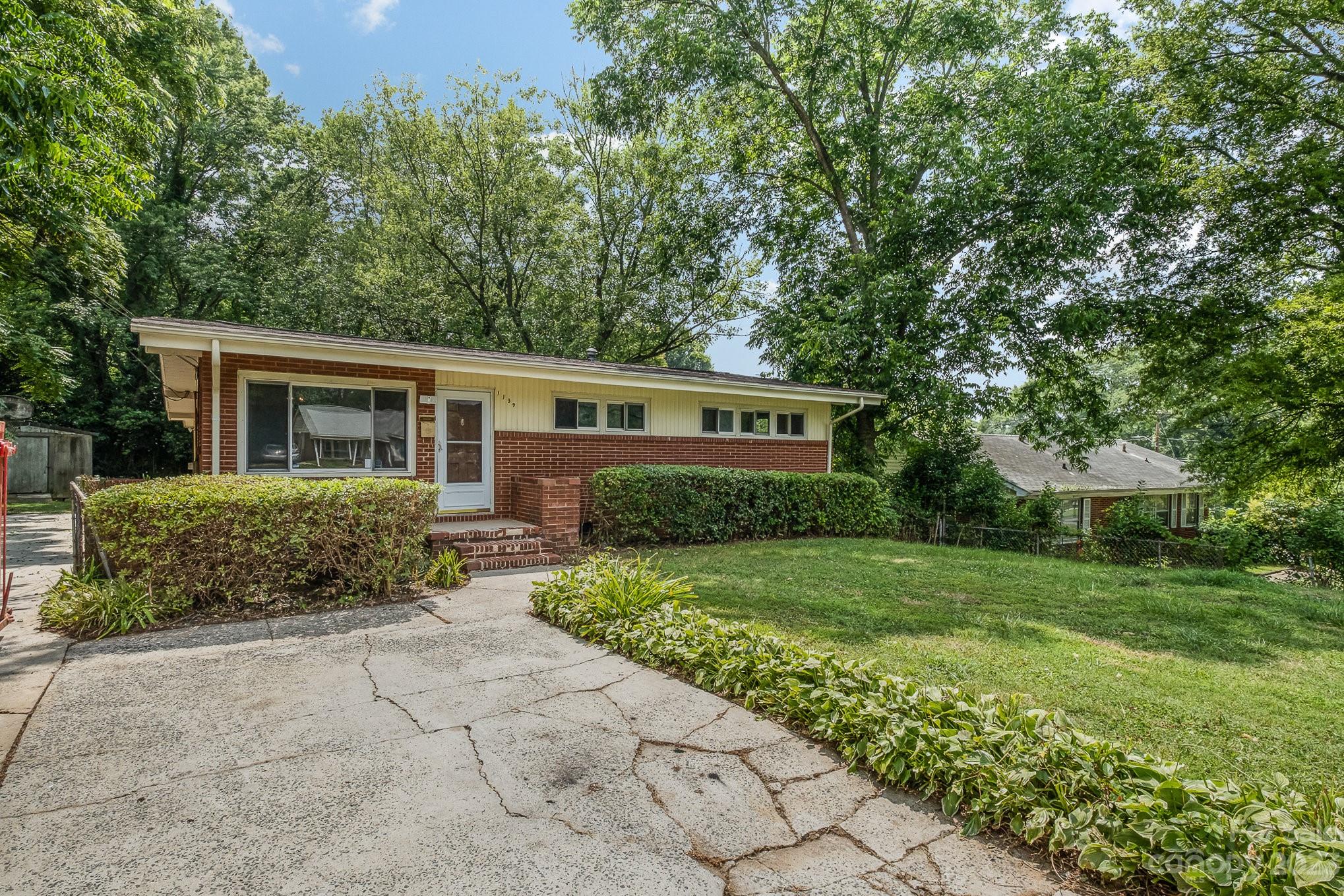 1139 Clanton Road Charlotte, NC 28217 - Photo 2 of 22 front view of a house with a yard