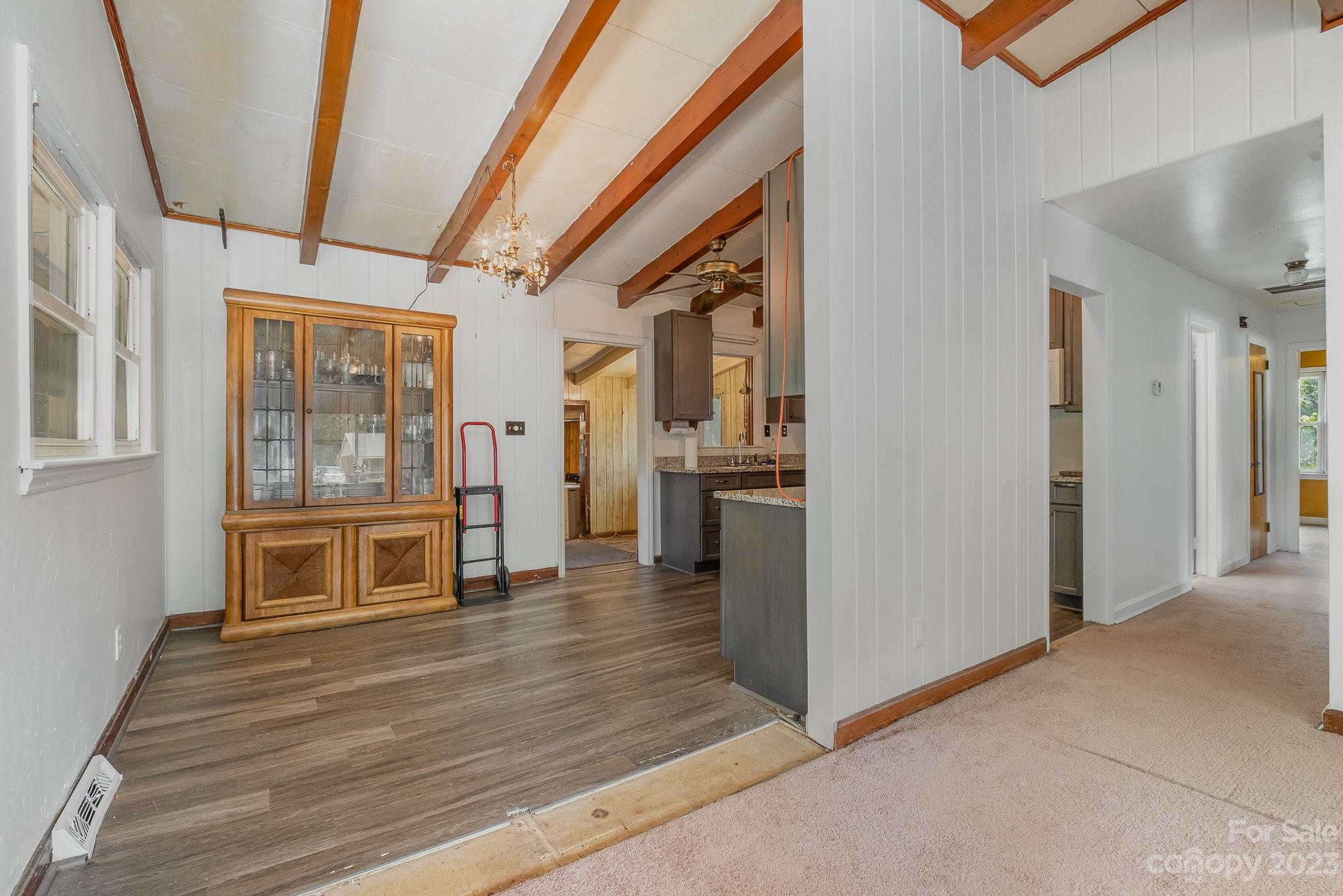 1139 Clanton Road Charlotte, NC 28217 - Photo 5 of 22 a view of an entryway with wooden floor and a kitchen