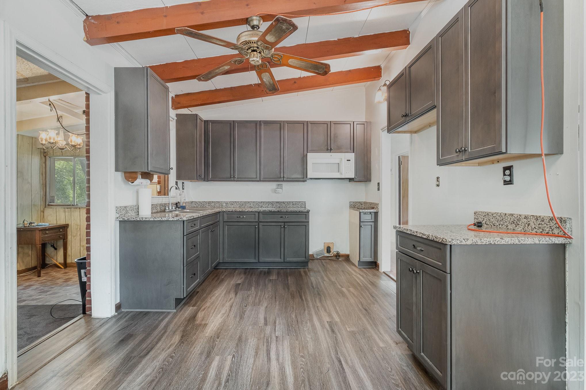 1139 Clanton Road Charlotte, NC 28217 - Photo 7 of 22 a kitchen with a sink window and cabinets