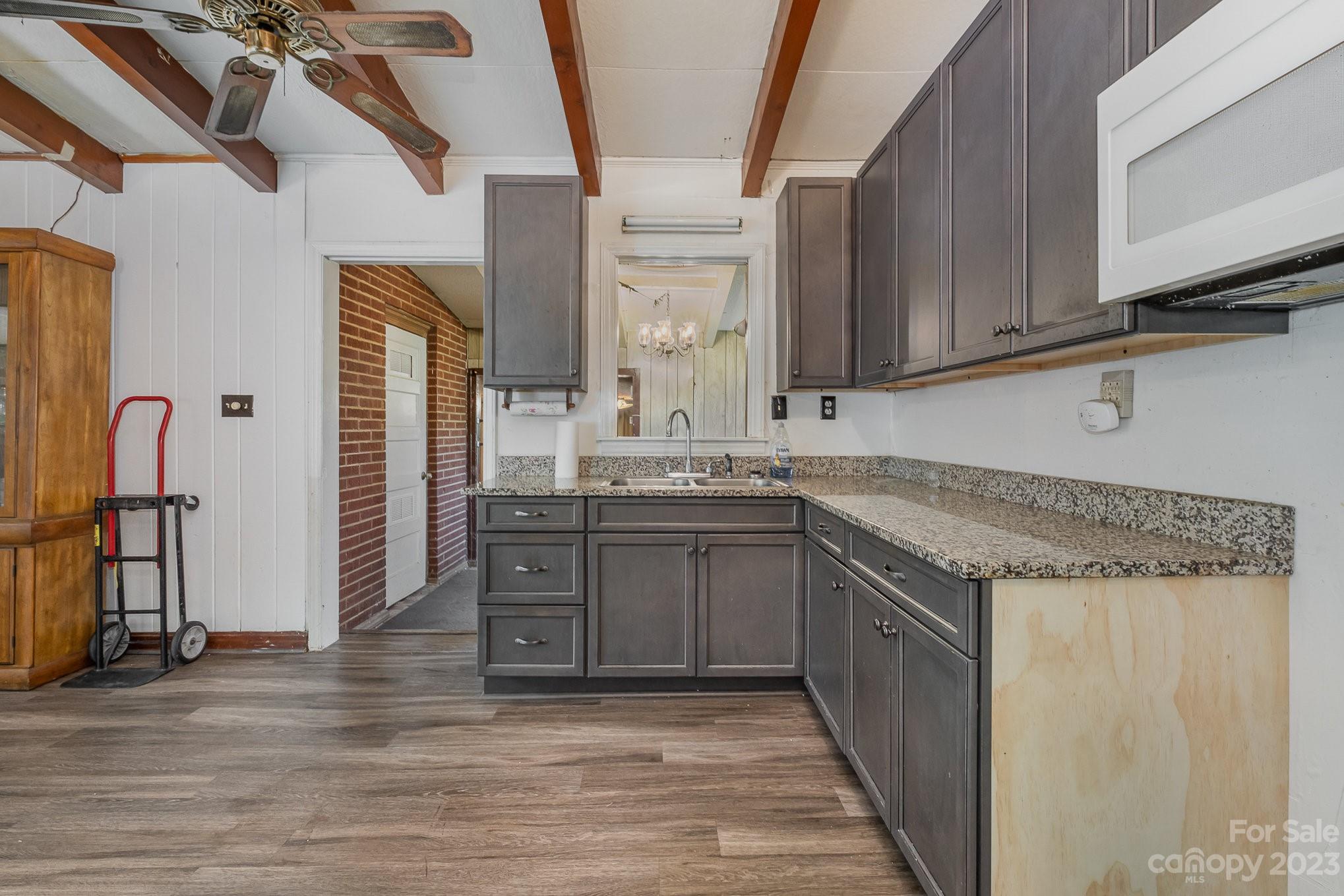 1139 Clanton Road Charlotte, NC 28217 - Photo 8 of 22 a kitchen with a sink cabinets and wooden floor