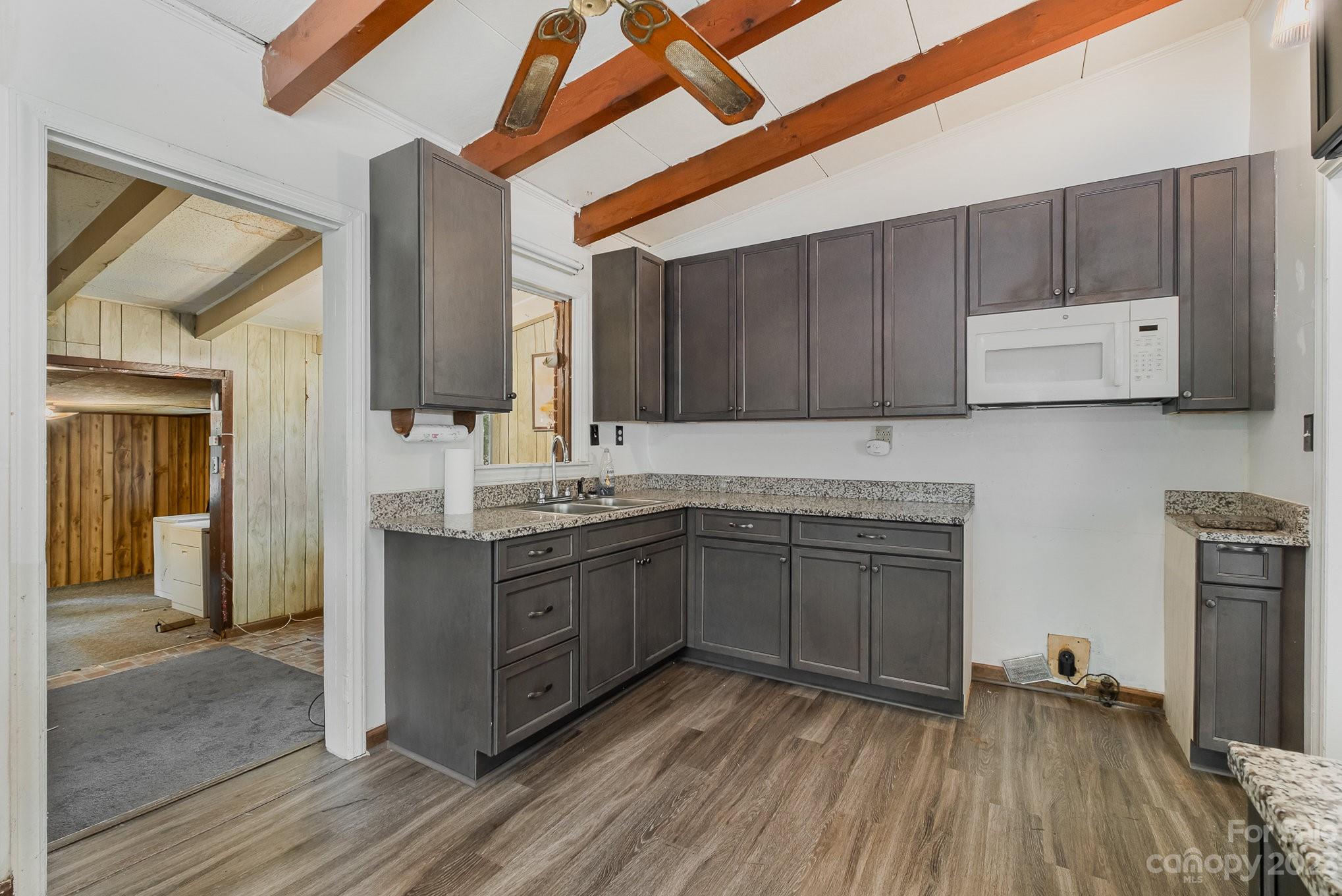 1139 Clanton Road Charlotte, NC 28217 - Photo 9 of 22 a kitchen with granite countertop a sink cabinets and wooden floor