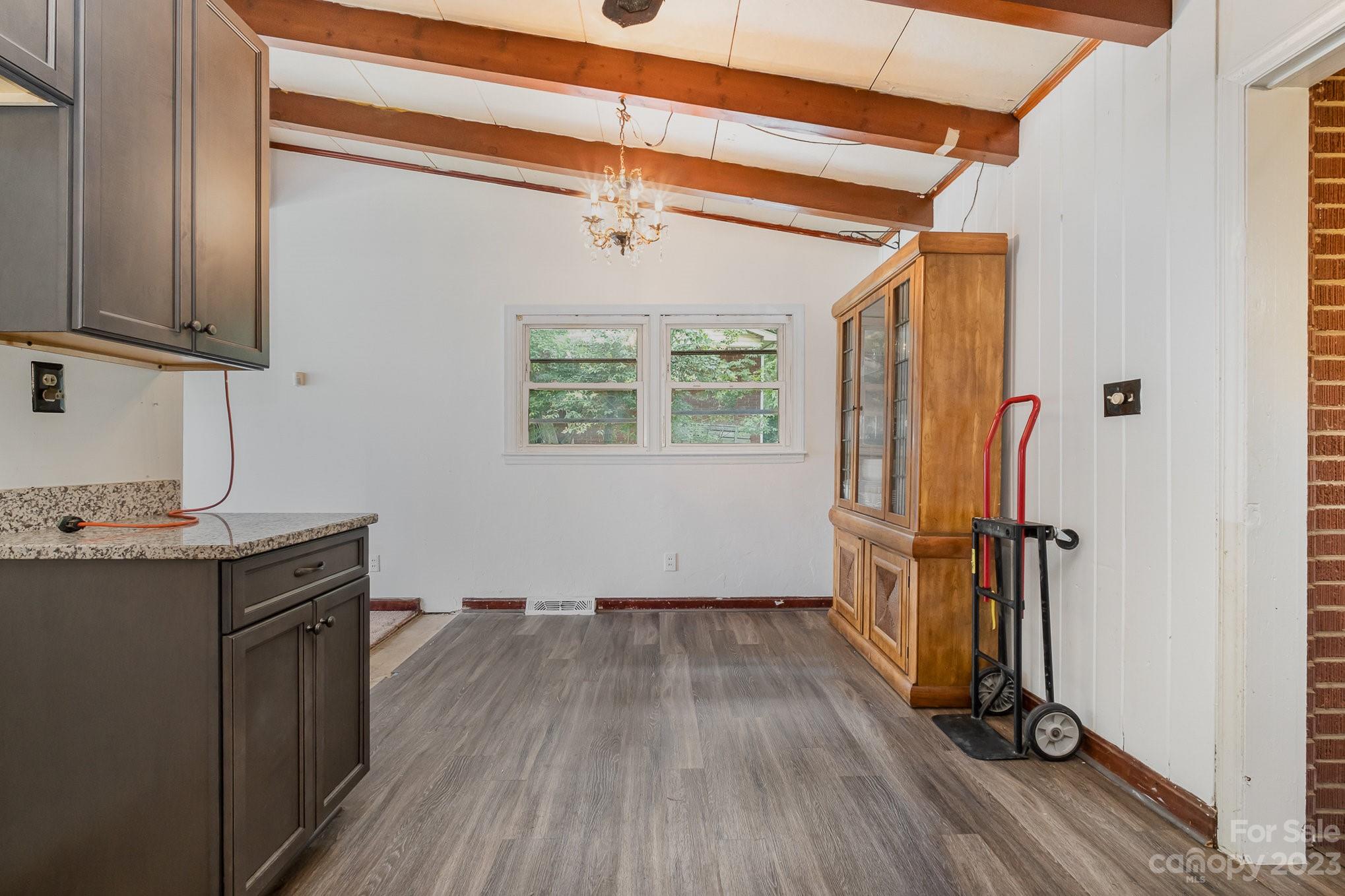 1139 Clanton Road Charlotte, NC 28217 - Photo 10 of 22 a view of hallway with wooden floor and stairs
