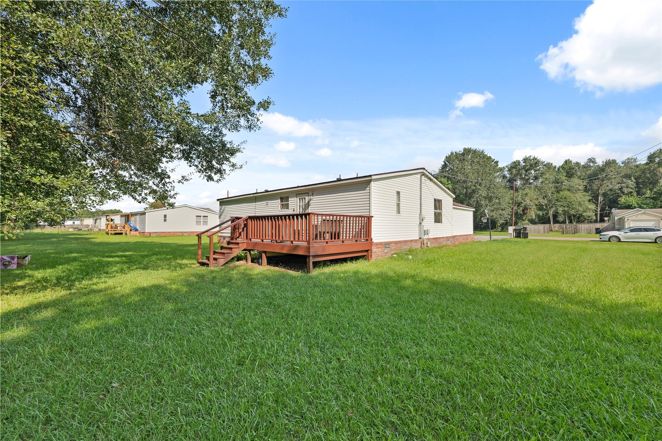 16572 River Ranch Drive Conroe, TX 77302 - Photo 19 of 24 a view of backyard with huge green area and wooden fence