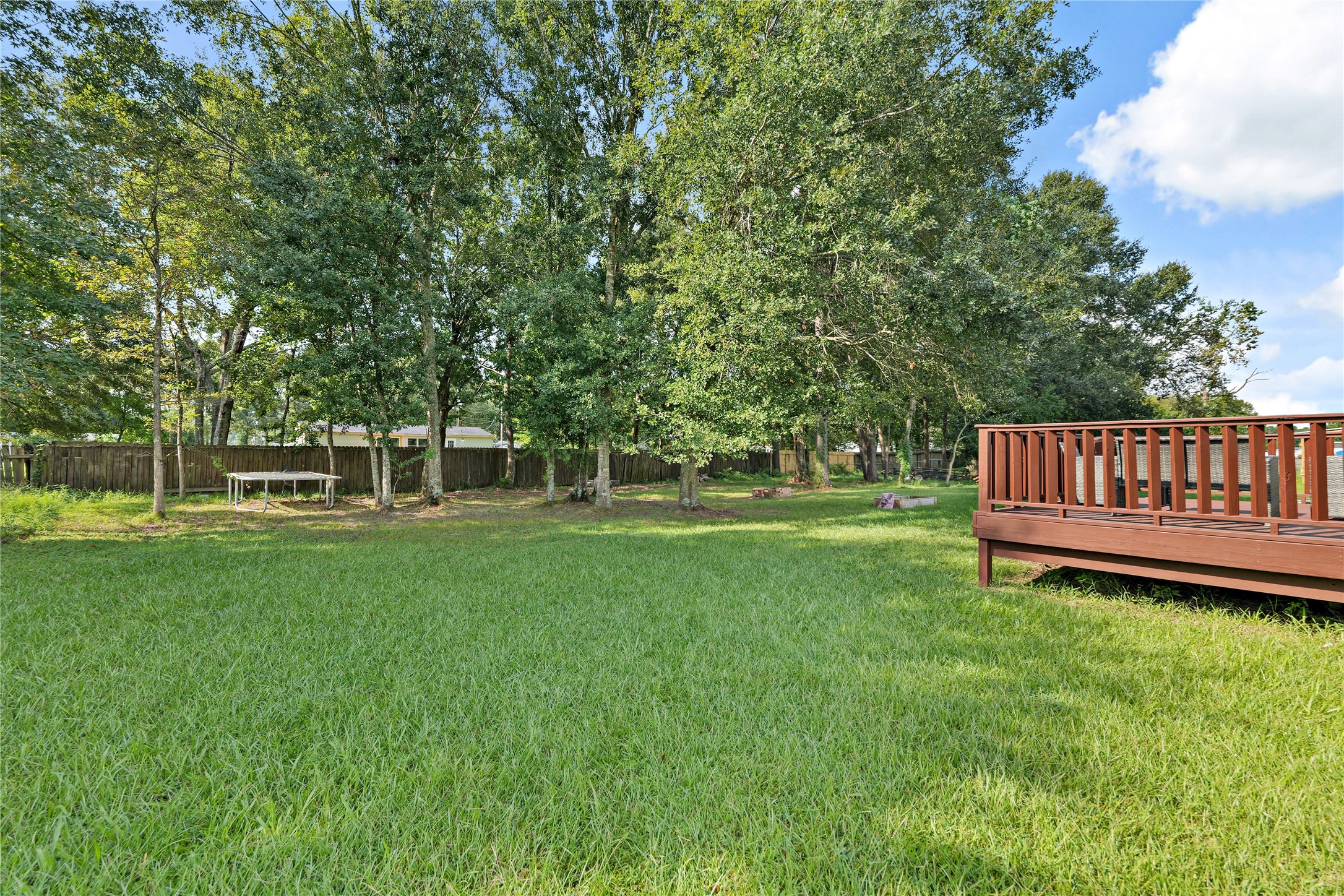 16572 River Ranch Drive Conroe, TX 77302 - Photo 21 of 24 a view of a chair and table in the garden