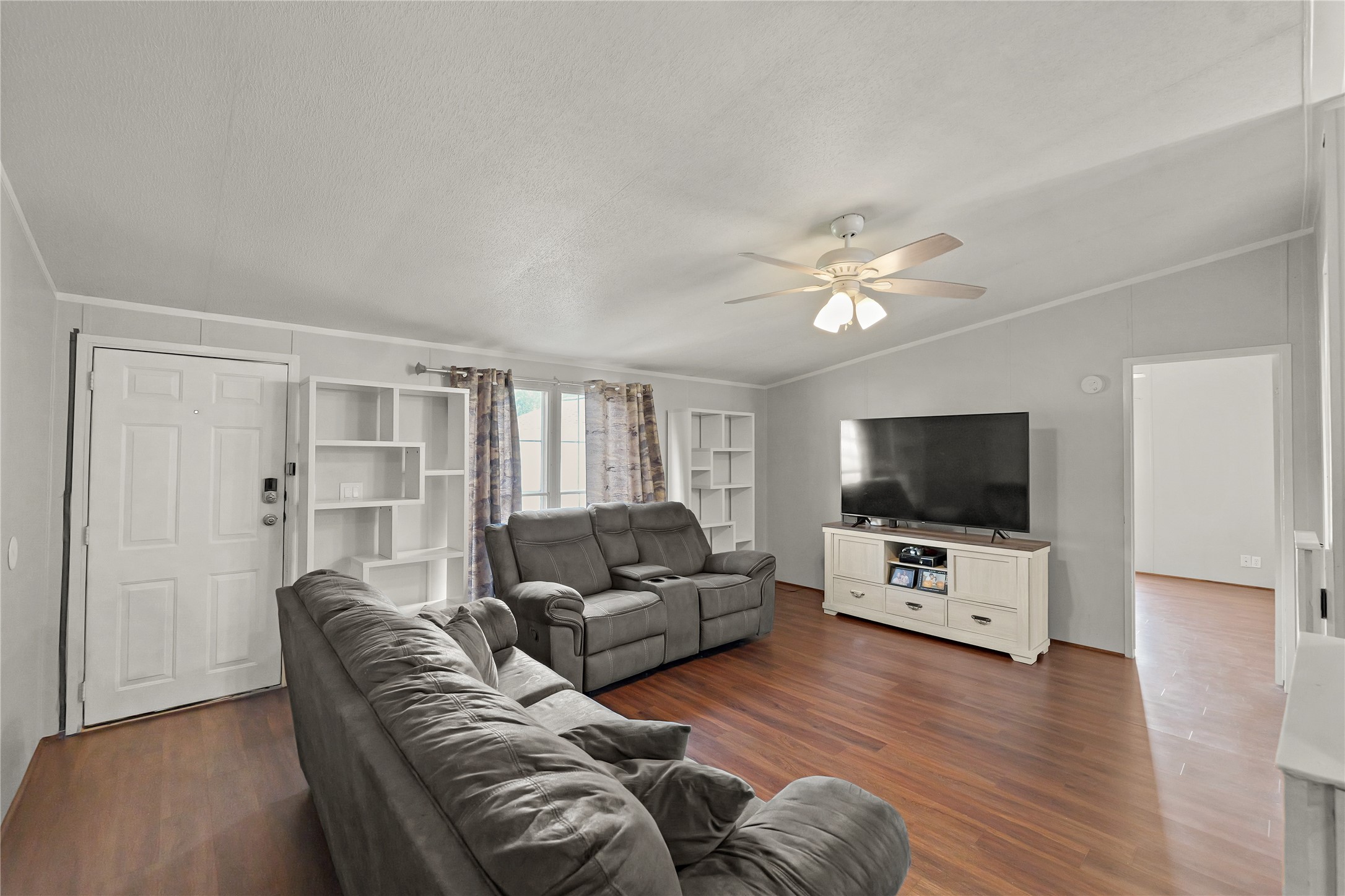 16572 River Ranch Drive Conroe, TX 77302 - Photo 6 of 24 a living room with furniture and a flat screen tv