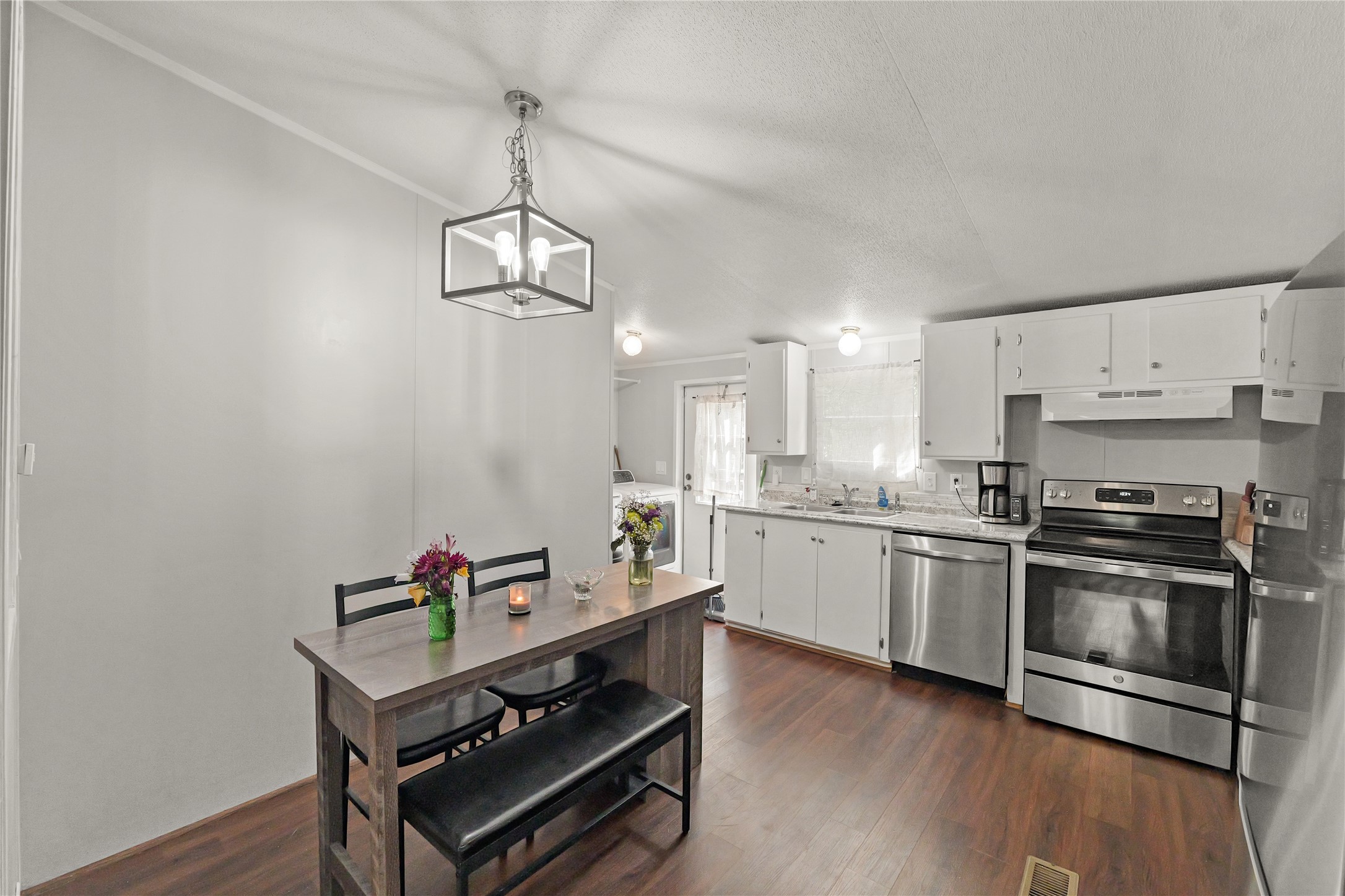 16572 River Ranch Drive Conroe, TX 77302 - Photo 7 of 24 a kitchen with stainless steel appliances granite countertop a stove a sink and a refrigerator