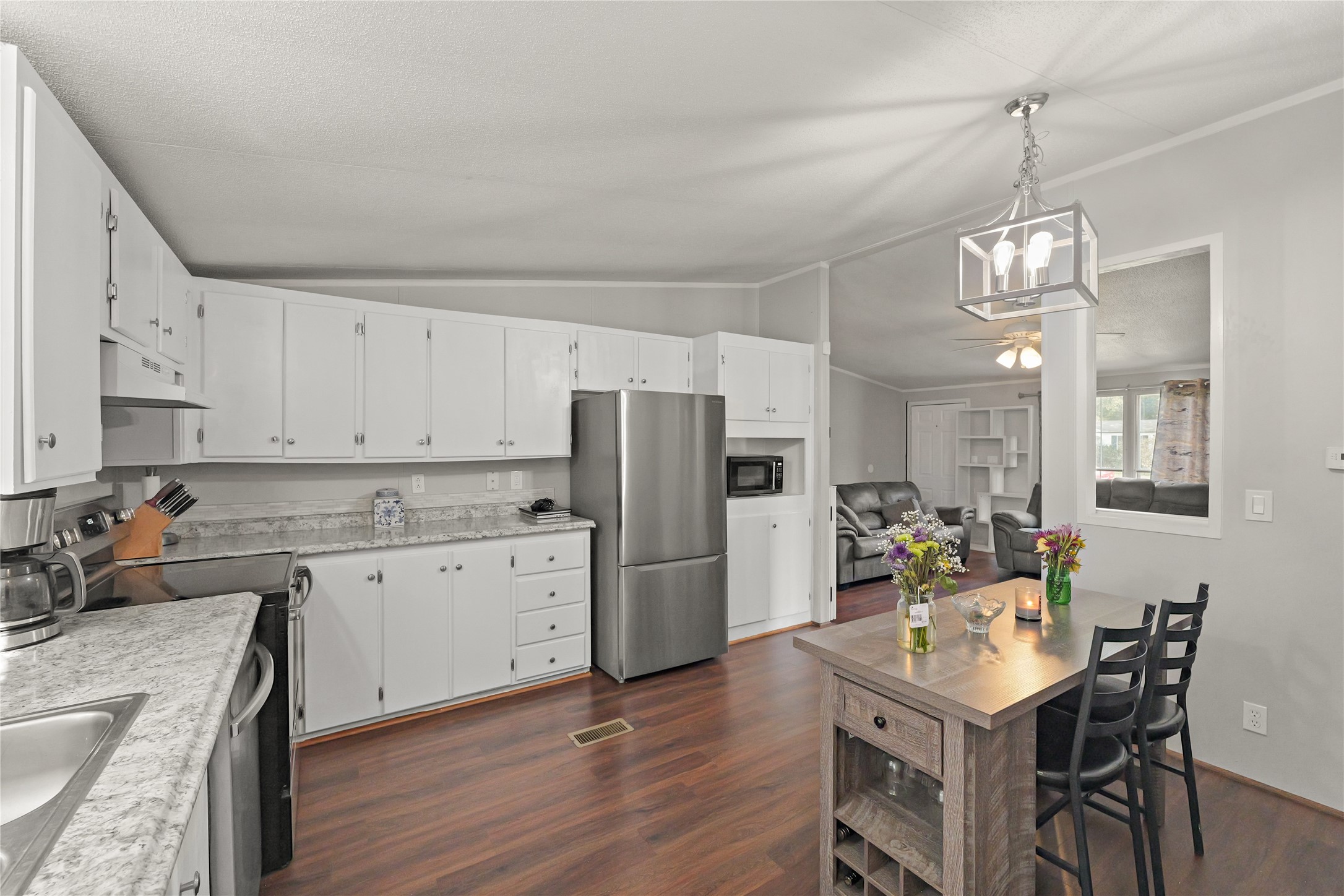 16572 River Ranch Drive Conroe, TX 77302 - Photo 10 of 24 a kitchen with refrigerator cabinets dining table and chairs
