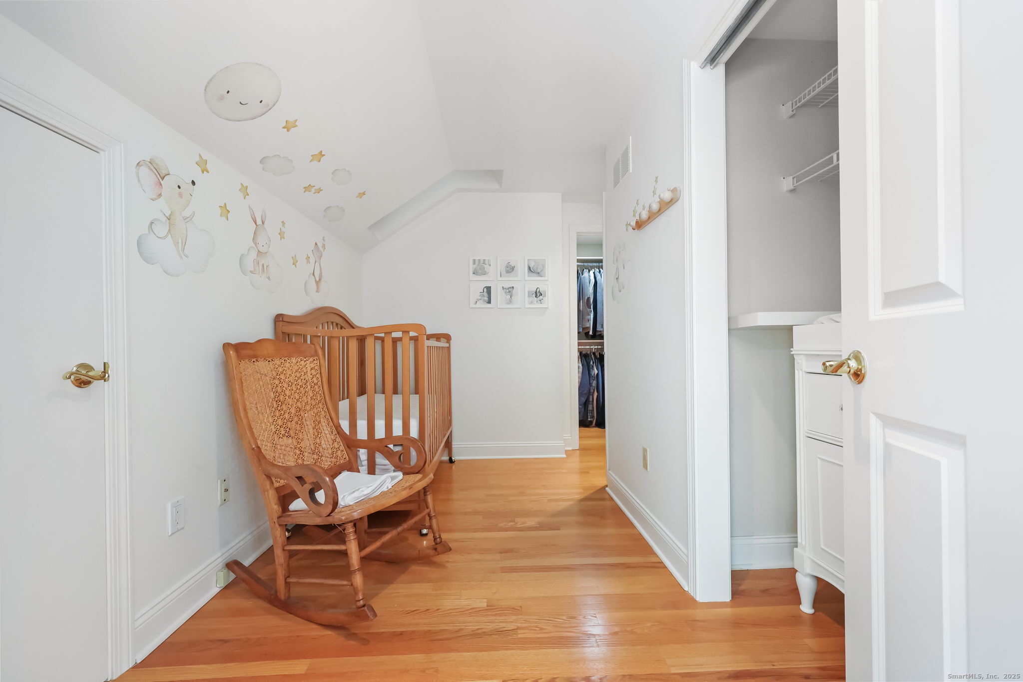 76 Hilary Circle, Unit 76 Fairfield, CT 06825 - Photo 11 of 29 a view of a hallway with chairs and wooden floor