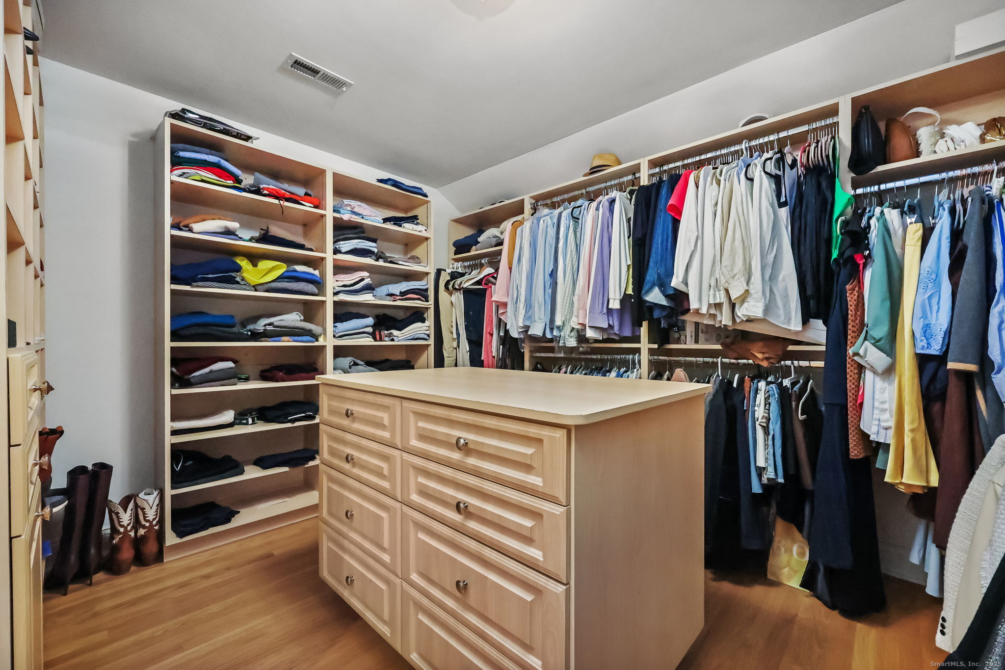 76 Hilary Circle, Unit 76 Fairfield, CT 06825 - Photo 12 of 29 a view of walk in closet with clothes and shoes
