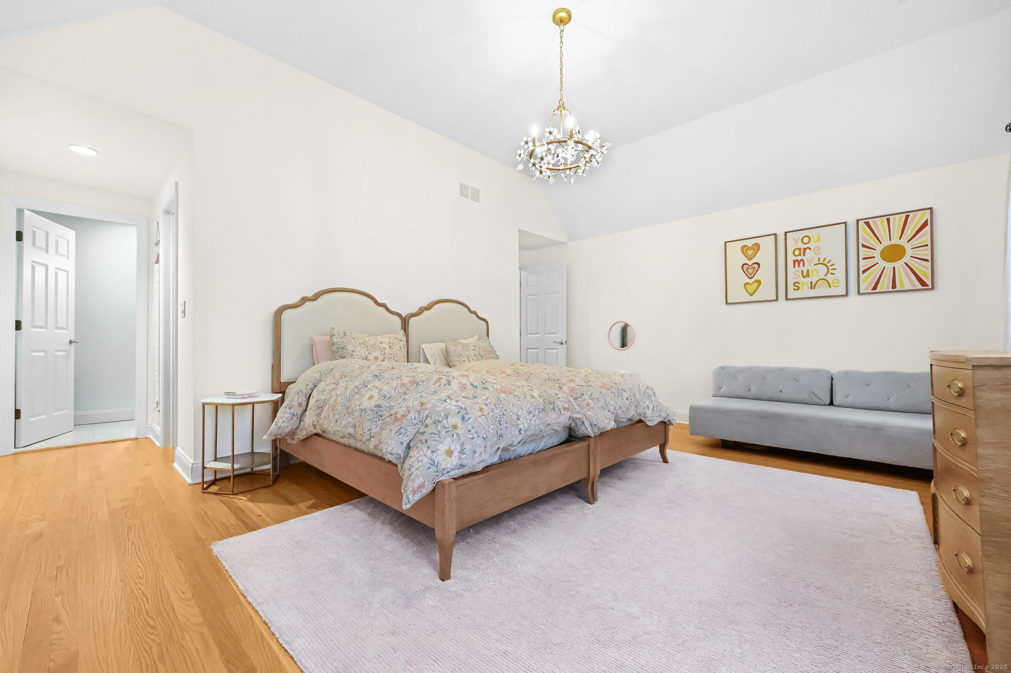 76 Hilary Circle, Unit 76 Fairfield, CT 06825 - Photo 16 of 29 a bedroom with a bed and a chandelier