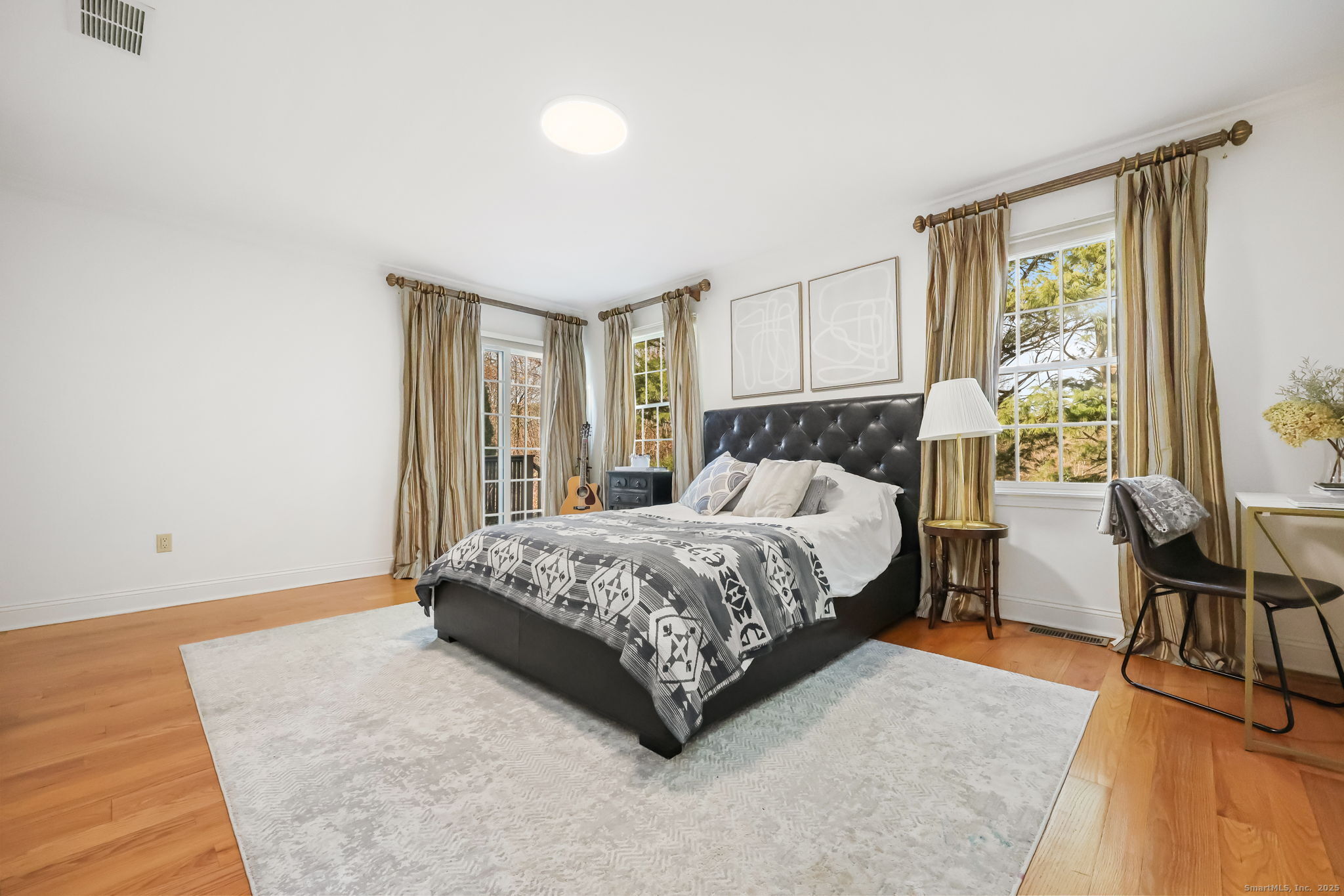 76 Hilary Circle, Unit 76 Fairfield, CT 06825 - Photo 17 of 29 a bedroom with a bed and large windows