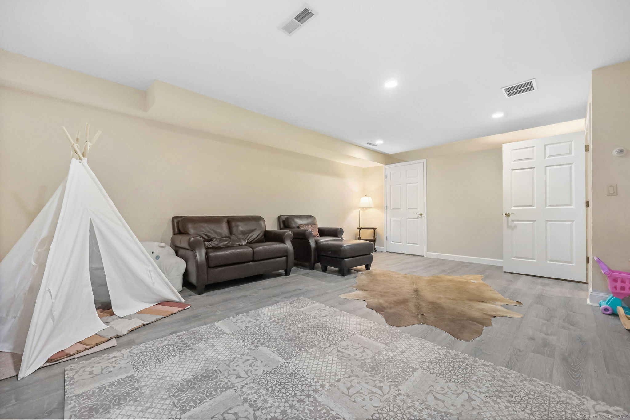 76 Hilary Circle, Unit 76 Fairfield, CT 06825 - Photo 19 of 29 a living room with furniture and a large window