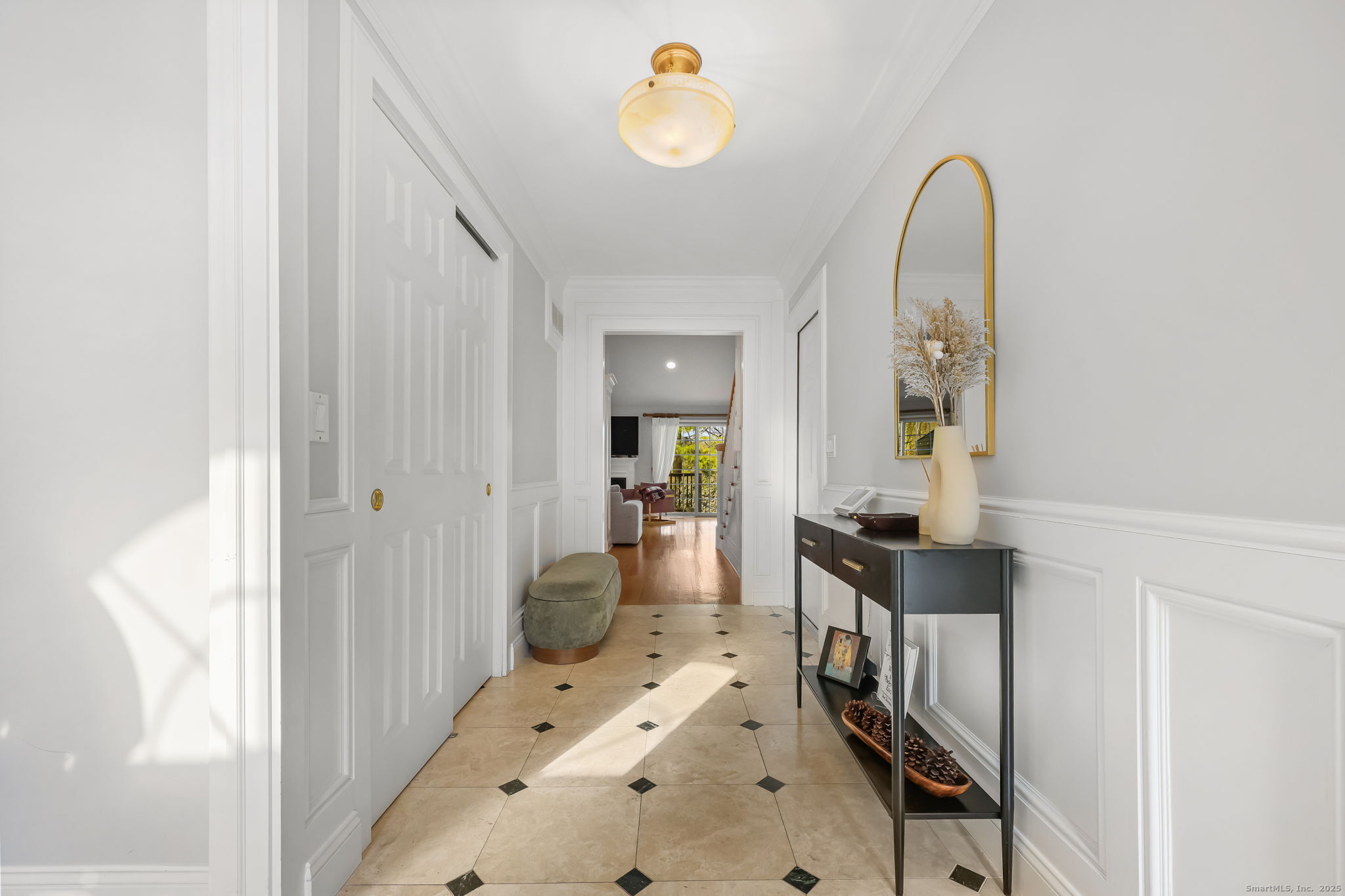 76 Hilary Circle, Unit 76 Fairfield, CT 06825 - Photo 2 of 29 a hall way with furniture a mirror and a window