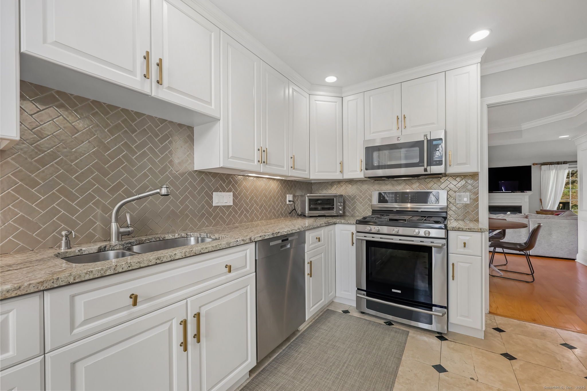 76 Hilary Circle, Unit 76 Fairfield, CT 06825 - Photo 3 of 29 a kitchen with stainless steel appliances granite countertop a sink stove and microwave