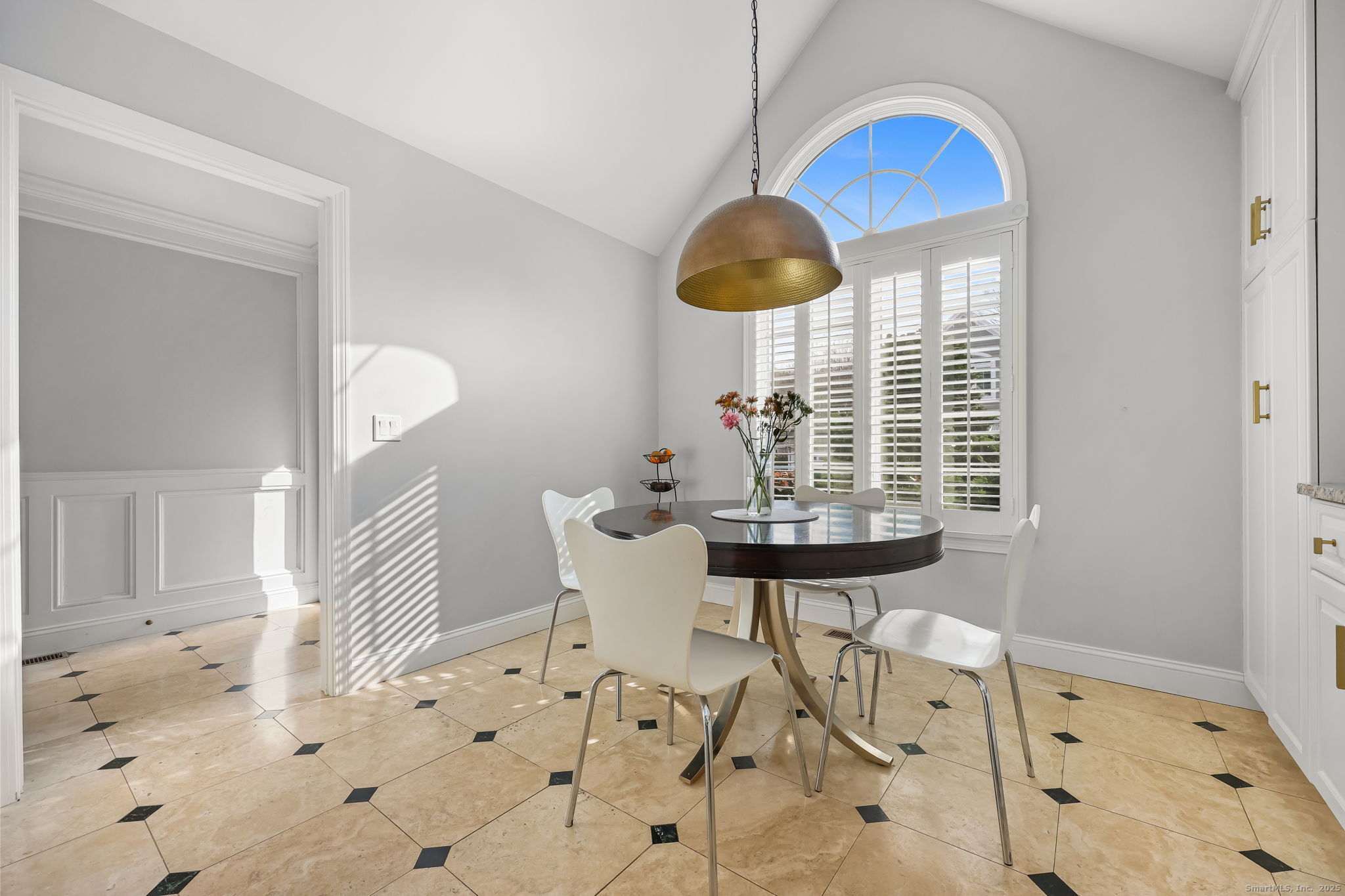 76 Hilary Circle, Unit 76 Fairfield, CT 06825 - Photo 4 of 29 a view of a dining room with furniture and a chandelier