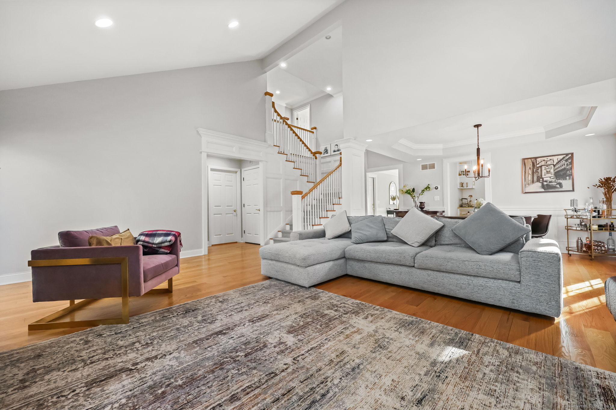 76 Hilary Circle, Unit 76 Fairfield, CT 06825 - Photo 6 of 29 a living room with furniture and wooden floor