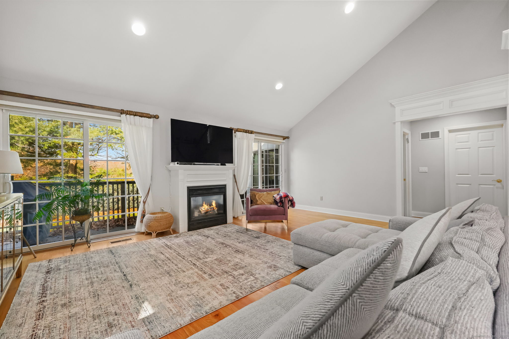 76 Hilary Circle, Unit 76 Fairfield, CT 06825 - Photo 7 of 29 a bedroom with a large bed and a fireplace