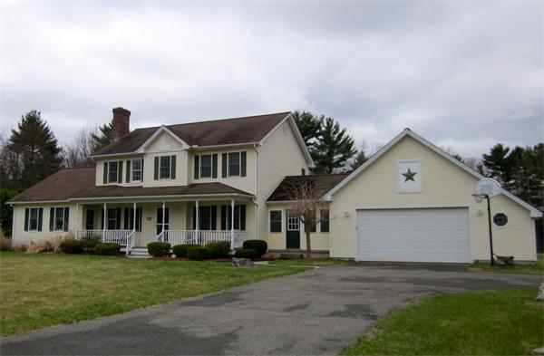 36 Strong Road Southampton, MA 01073 - Photo 1 of 20 a front view of a house with a yard and garage