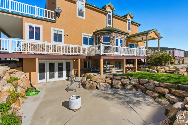 4768 East Hickman Canyon Road Stockton, UT 84071 - Photo 58 of 85 south side view of property with stucco siding, french doors and a patio.