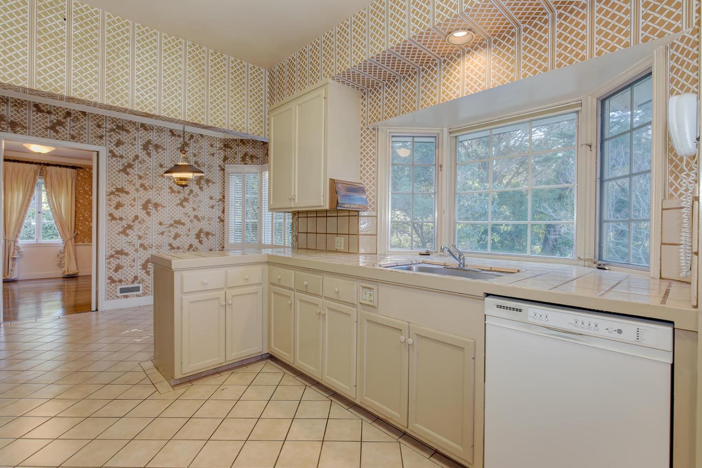 540 Roehampton Road Hillsborough, CA 94010 - Photo 11 of 27 a kitchen with granite countertop white cabinets and white appliances