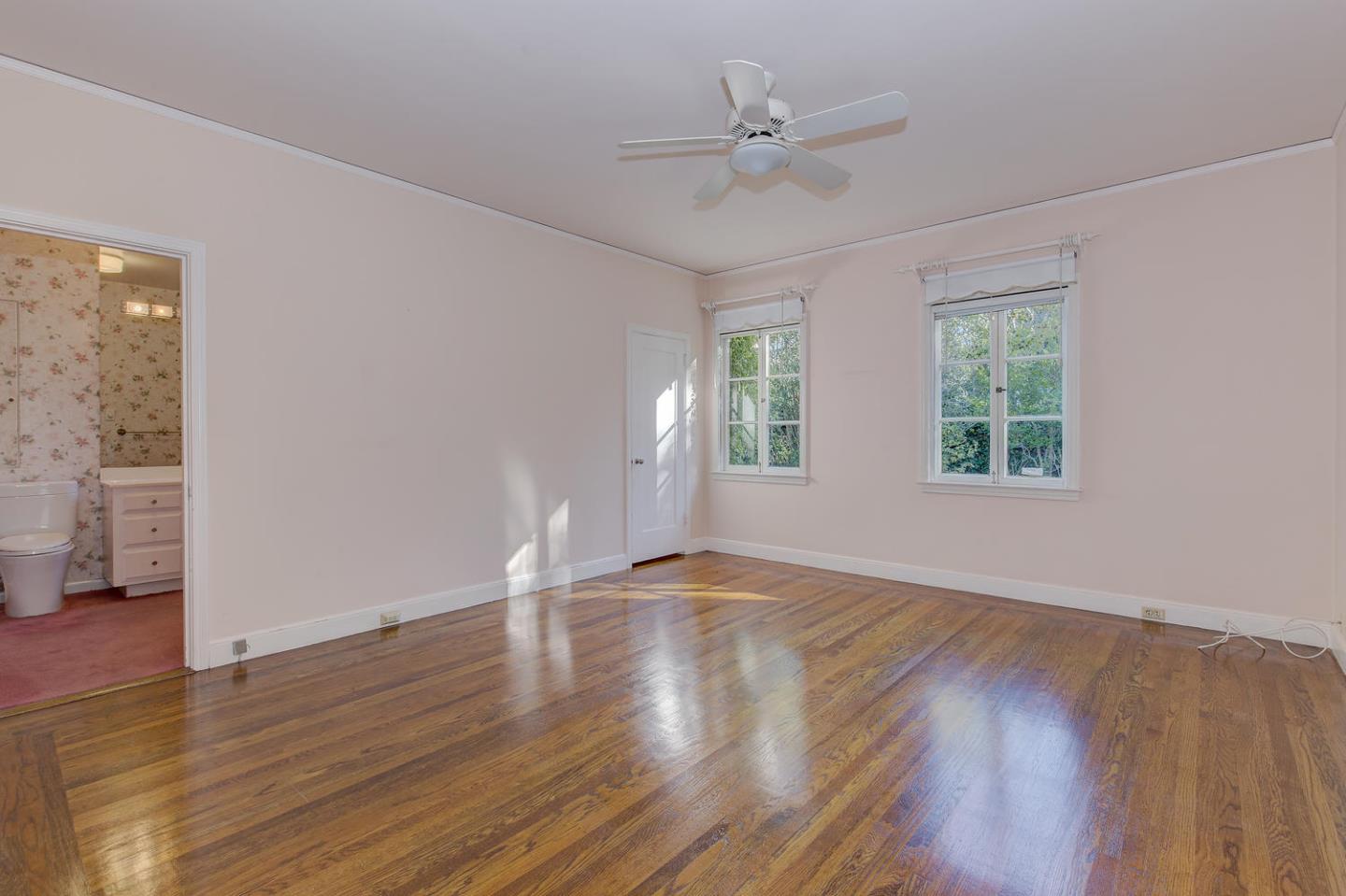 540 Roehampton Road Hillsborough, CA 94010 - Photo 13 of 27 a view of an empty room with wooden floor and a window